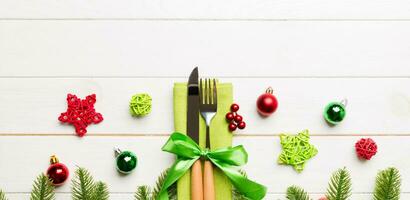 Top view of festive cutlery on new year wooden background. Banner Christmas decorations with empty space for your design. Holiday dinner concept photo