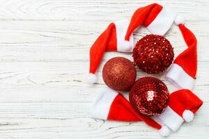 Top view of festive winter composition on wooden background with empty space for your design. Christmas baubles and decorations. New Year concept photo
