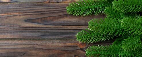 Top view Banner of frame made of fir tree branches on wooden background. Christmas concept with empty space for your design photo