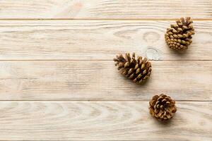 Christmas pine cones on colored paper border composition. Christmas, New Year, winter concept. Flat lay, top view, copy space photo