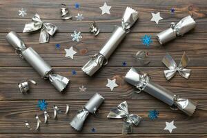 Christmas crackers with shiny confetti on color background, top view, copy space photo