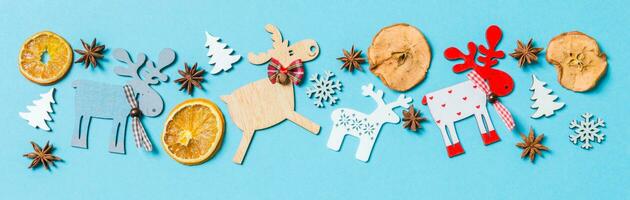 Top view of holiday decorations and toys on blue background. Banner Christmas ornament concept with empty space for your design photo