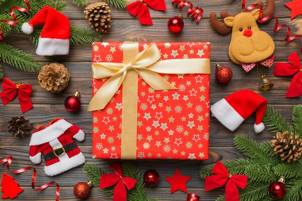 Gift boxes, candy canes and cypress branches. Christmas preparation of  gifts on red and beige wrapping paper. New Year concept. Top view, flat lay  Stock Photo - Alamy