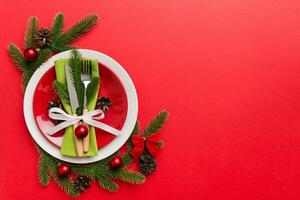 Christmas table place setting with christmas decor and plates, kine, fork and spoon. Christmas holiday background. Top view with copy space photo