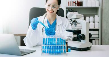 female scientist working with micro pipettes analyzing biochemical samples, advanced science chemical laboratory for medicine. photo