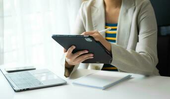 Young Woman Account Manager Working at Table with New Business Project. Typing keyboard,Using Contemporary Laptop. photo