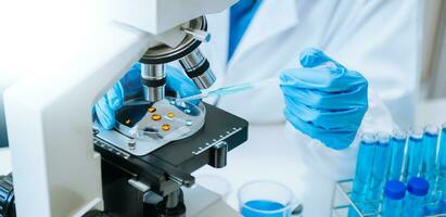 Modern medical research laboratory. female scientist working with micro pipettes analyzing biochemical samples, advanced science chemical laboratory photo