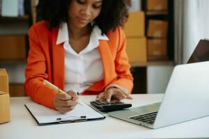 Hand business doing finances and calculate on desk about cost using on smartphone and tablet as concept photo