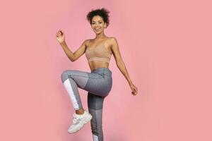 Pretty african woman with stislish hairstyle posing in studio photo