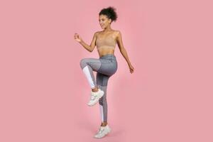 Pretty african woman with stislish hairstyle posing in studio photo