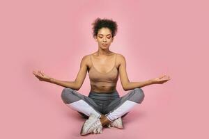 Pretty african woman with stislish hairstyle posing in studio photo