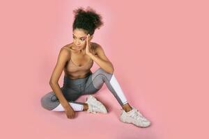 Pretty african woman with stislish hairstyle posing in studio photo