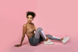 Pretty african woman with stislish hairstyle posing in studio photo