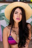 Close up portrait of sensual woman in straw hat with perfect long hairs  posing in beach bar. Summer mood. photo