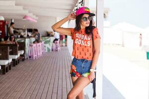 Outdoor   lifestyle  portrait of young amazing brunette woman , orange print t-shirt . photo