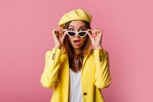 a woman in a yellow jacket and white pants photo