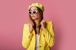 a woman in a yellow jacket and white pants photo