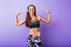 Exited sporty woman  demonstrate muscule in studio. photo