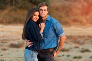 Lifestyle portrait of Young attractive  couple in love  posing  outdoor in the evening . photo