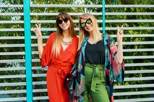 Two sisters, pretty elegant women enjoying summer holidays. Walking and spending time together. photo