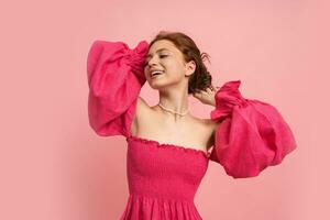 Summer studio photo of romantic young woman in pink linen dress posing  in studio.