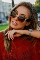 Close up  portrait of beautiful european woman in sunglasses  posing outdoor. Autumn mood. Windy hairs. photo