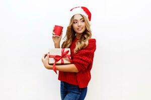 New year or Christmas Eve mood. Blond attractive girl in masquerade hat holding gift boxes isolate on white background. Joyful mood. Copy space for text. photo