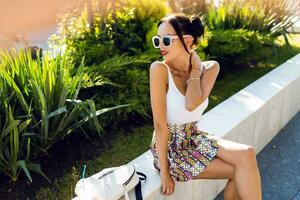 Pretty brunette woman posing  outdoor in sunny summer day. photo