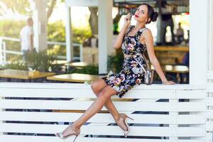 Pretty brunette woman posing  outdoor in sunny summer day. photo