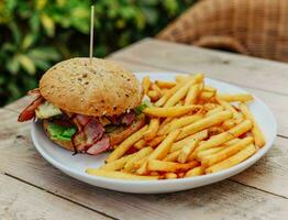 Classic American dish of cheeseburger with fries photo