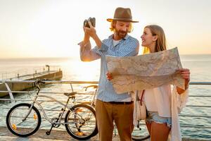 attractive happy couple traveling in summer on bicycles photo