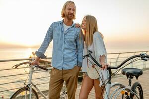 attractive happy couple traveling in summer on bicycles photo