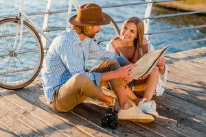 attractive happy smiling couple traveling in summer by sea photo