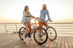 attractive happy couple traveling in summer on bicycles photo