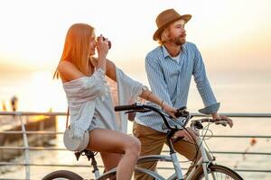 attractive happy couple traveling in summer on bicycles photo