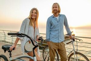 attractive happy couple traveling in summer on bicycles photo