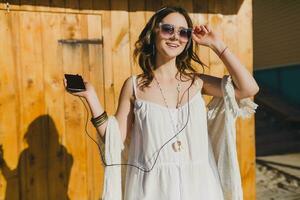 beautiful woman in white summer dress by the sea photo