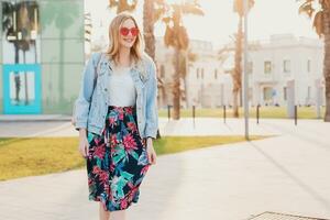 pretty smiling woman walking in city street photo