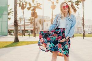 pretty smiling woman walking in city street photo