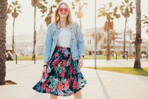 pretty smiling woman walking in city street photo