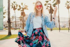 pretty smiling woman walking in city street photo