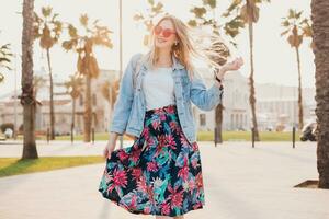 pretty smiling woman walking in city street photo