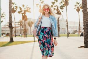 pretty smiling woman walking in city street photo