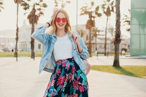 pretty smiling woman walking in city street photo