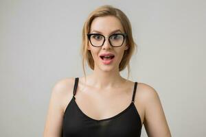 young attractive woman in glasses, grey background photo