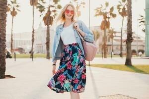 pretty smiling woman walking in city street photo