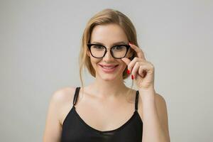 young attractive woman in glasses, grey background photo