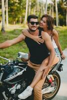 young couple in love, riding a motorcycle, hug, passion, free spirit photo