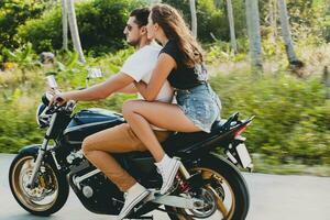 young couple in love, riding a motorcycle, hug, passion, free spirit photo