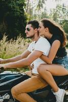 young couple in love, riding a motorcycle, hug, passion, free spirit photo